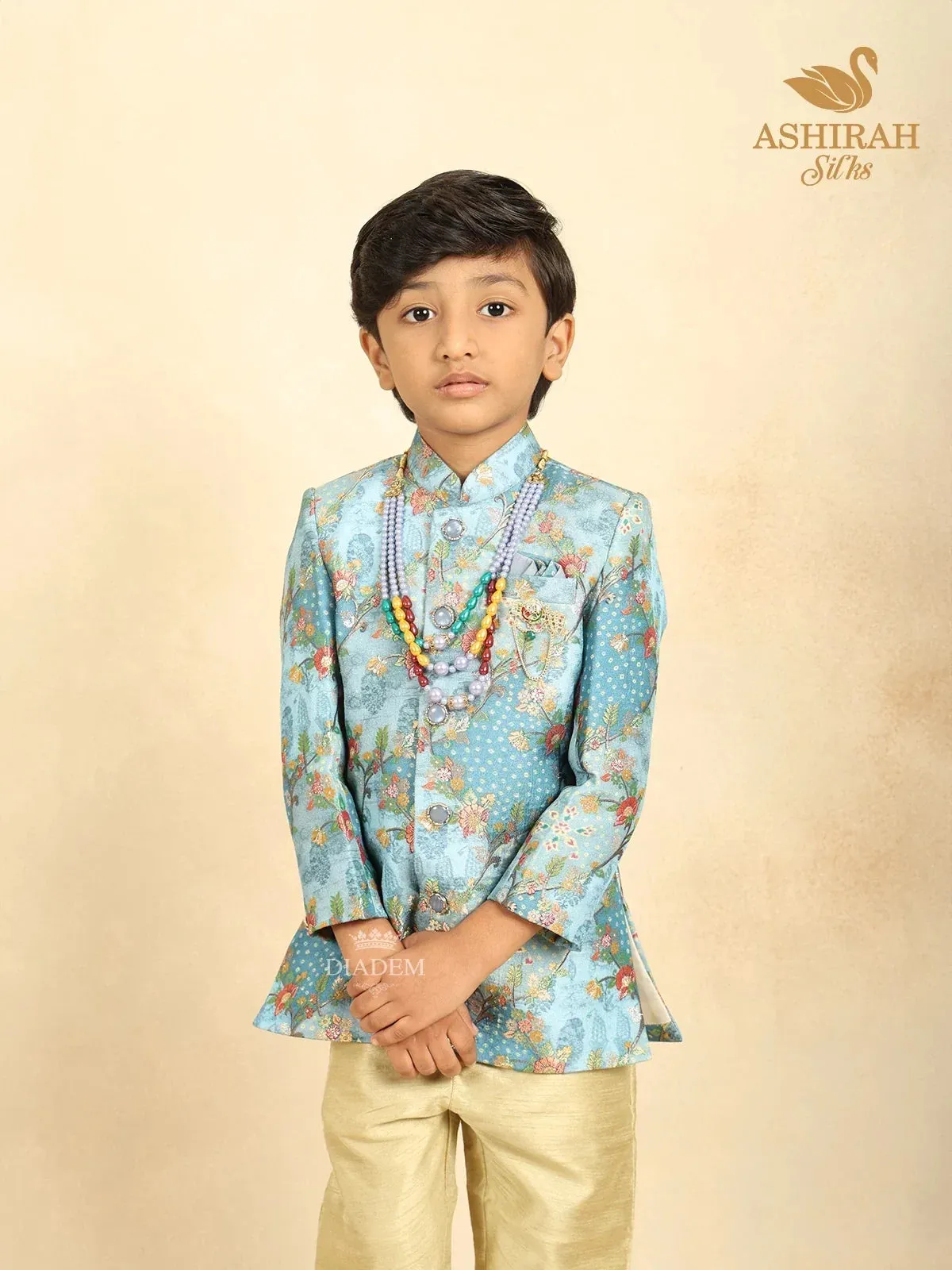 Coral Blue Raw Silk Sherwani with Floral Prints paired with Contrast Pant and Pearl Mala